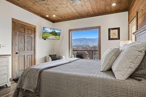 Drift off to sleep in this rustic mountain retreat with stunning views and cozy wood details throughout.