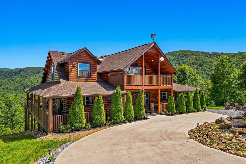 A spacious log cabin nestled in lush mountains with private parking and landscaped grounds, offering a perfect mountain retreat surrounded by nature.