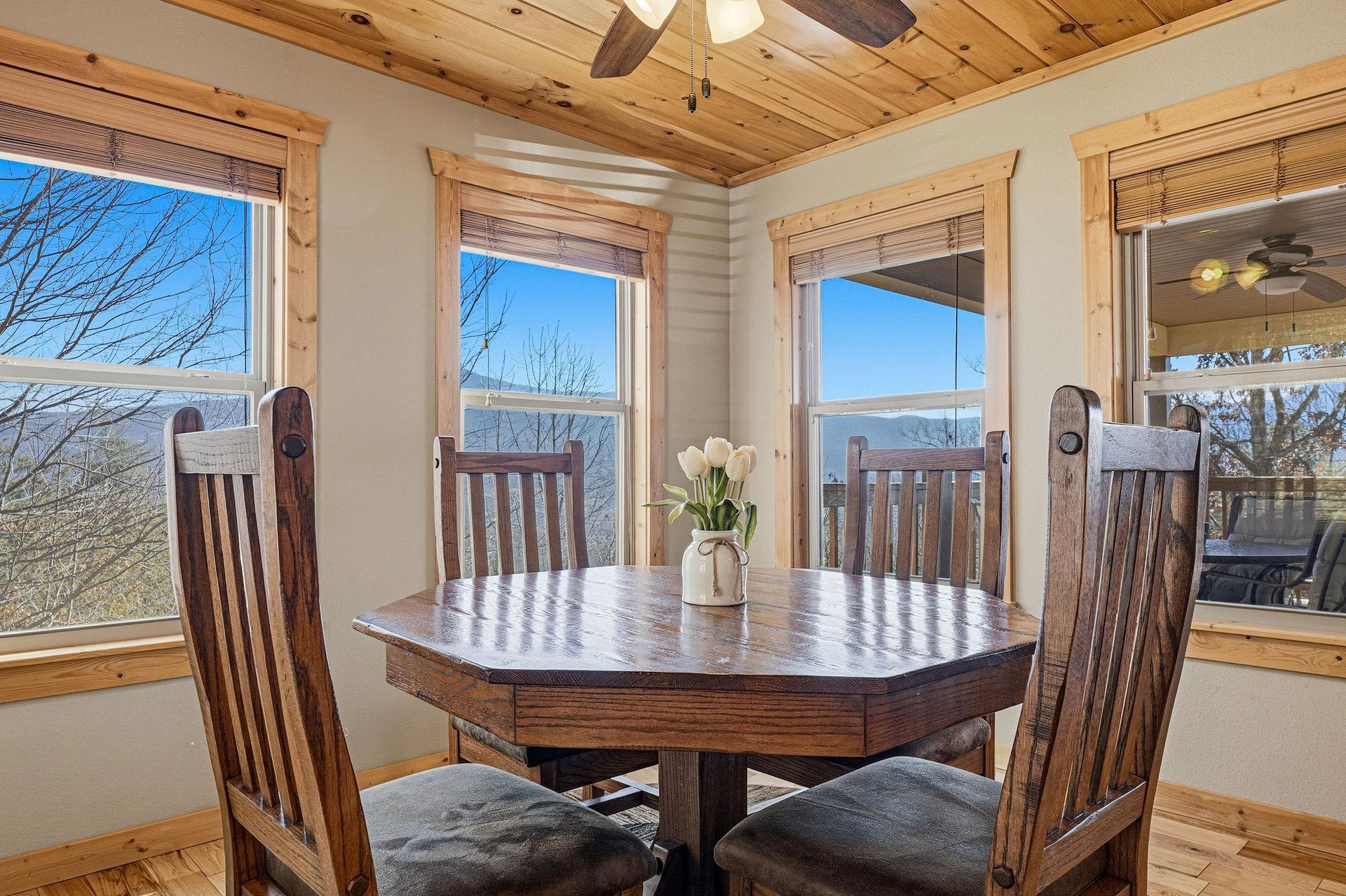 Savor meals at your elegant dining table while soaking in breathtaking mountain views through expansive windows in this rusticchic space.