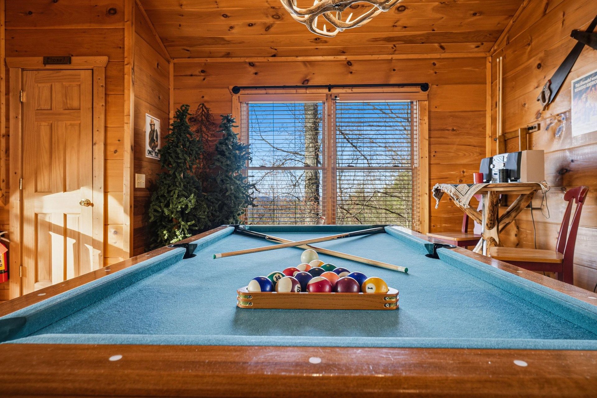 Challenge your friends to a game in your cozy log cabin game room, complete with billiards table and rustic mountain charm.