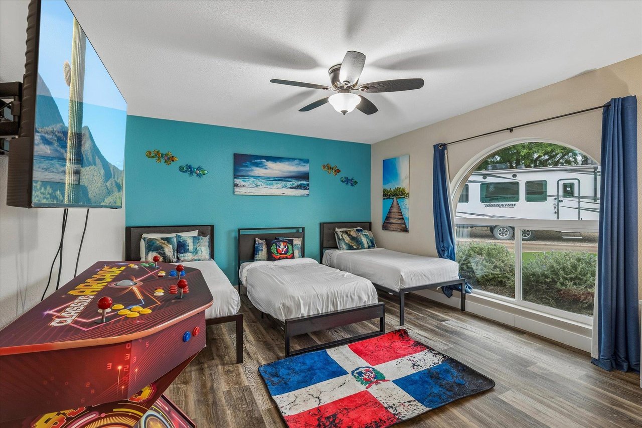 Three twin beds, flatscreen TV, large window with plenty of natural lighting, and games for all ages