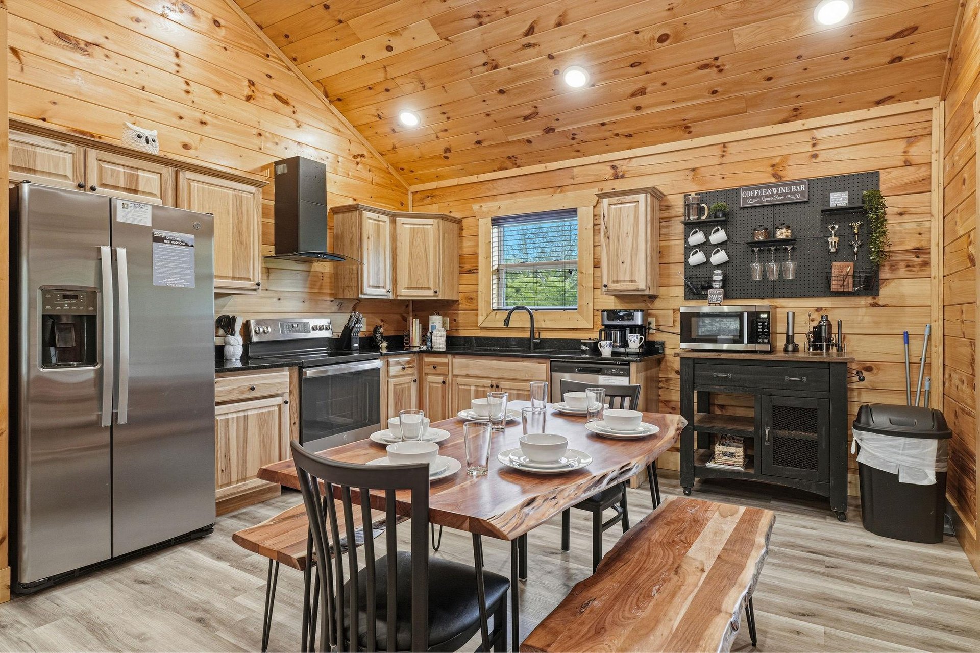 Your fully equipped cabin kitchen invites you to gather around the rustic wood table, with warm pine walls, modern appliances, and everything you need to cook and share memorable meals together.