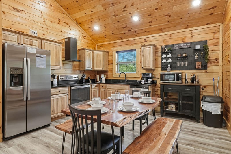 Your fully equipped cabin kitchen invites you to gather around the rustic wood table, with warm pine walls, modern appliances, and everything you need to cook and share memorable meals together.
