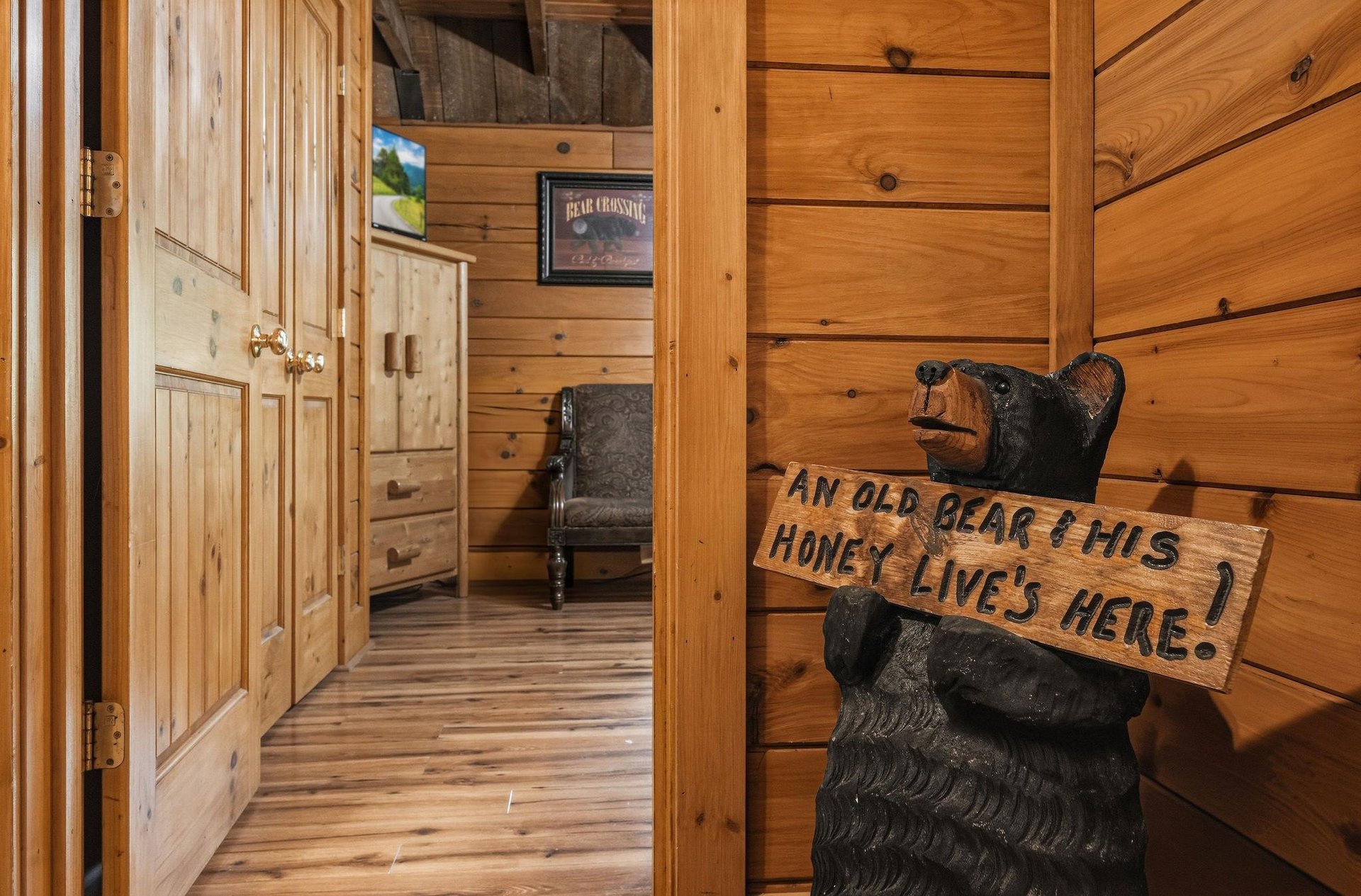 Step into your cozy cabin retreat, where rustic charm meets comfort. From the warm wood floors beneath your feet to the carved bear welcoming you home, every corner invites you to unwind and relax.