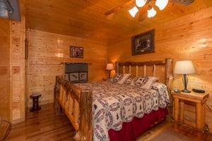 Bedroom with a log bed, night stand, and lamp at Country Bears Getaway, a 3bedroom cabin rental located in Gatlinburg