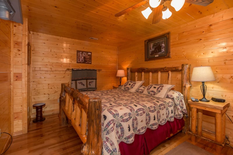 Bedroom with a log bed, night stand, and lamp at Country Bears Getaway, a 3bedroom cabin rental located in Gatlinburg