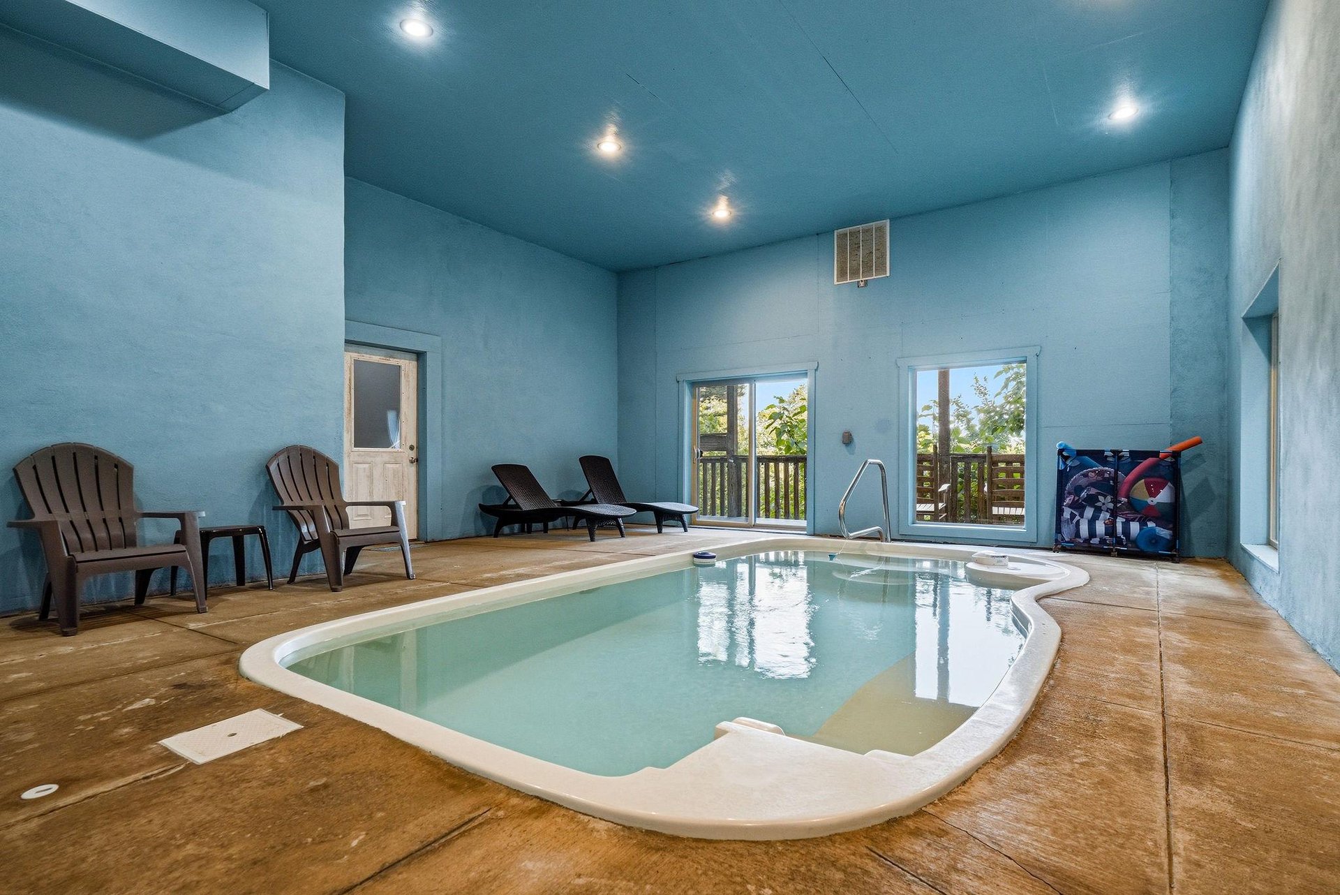 Soak away your cares in your private indoor pool, complete with lounge chairs and serene natural light streaming through large windows—perfect for relaxing any time of year.