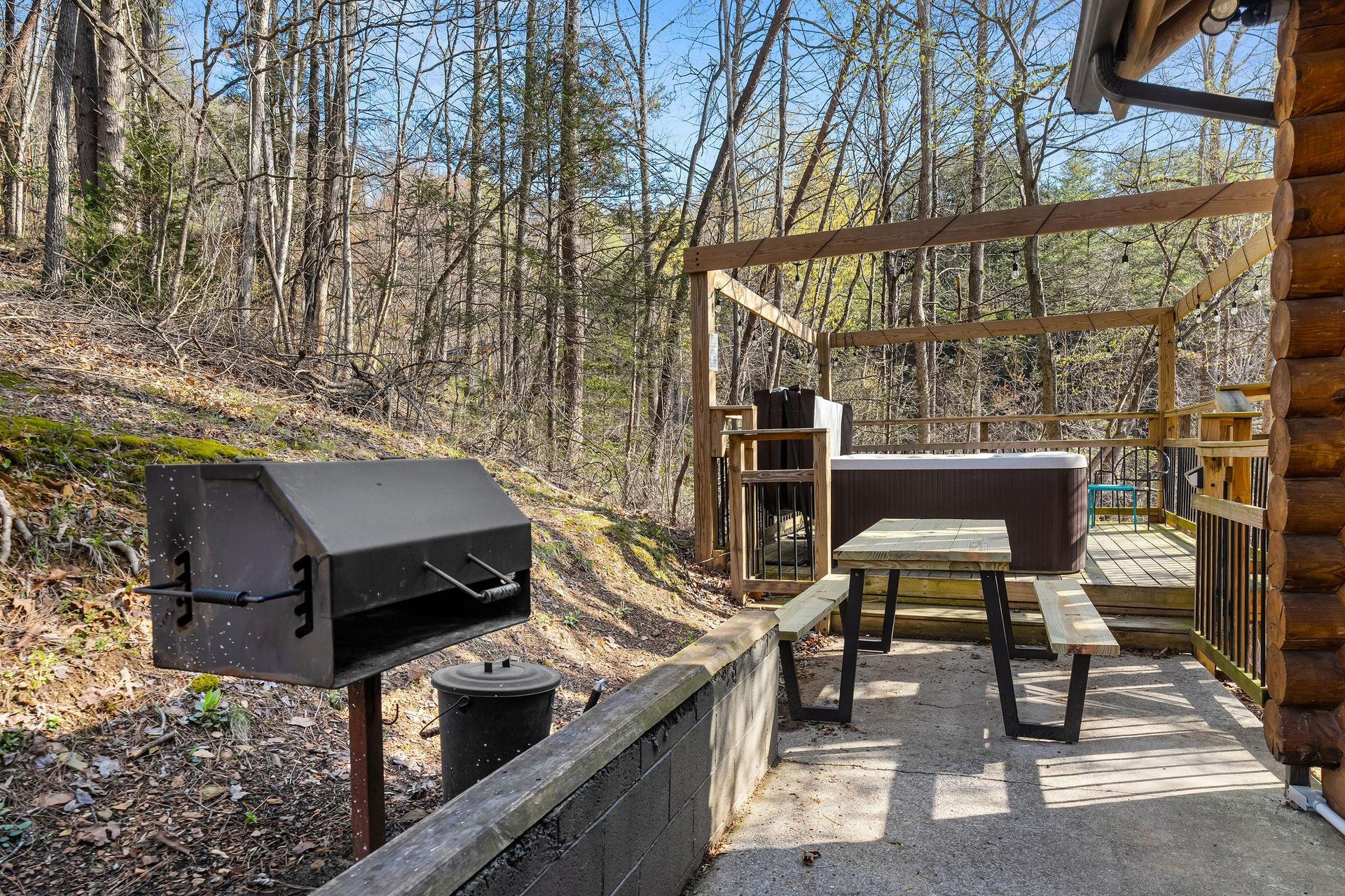 grill and seating next to outdoor hot tub