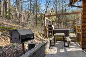 grill and seating next to outdoor hot tub