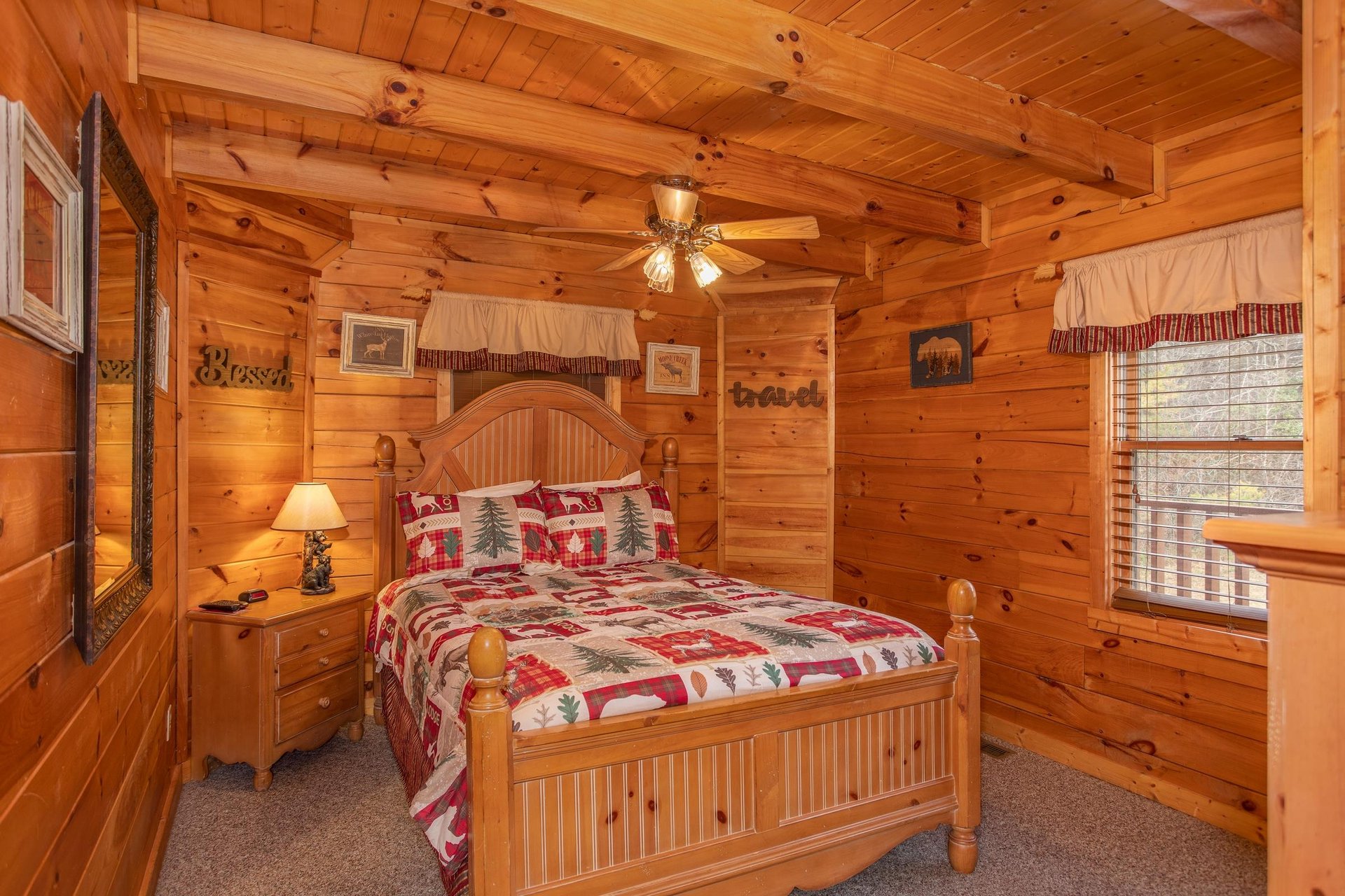 Bedroom with a queensized bed at Hibernation Station, a 3bedroom cabin rental located in Pigeon Forge