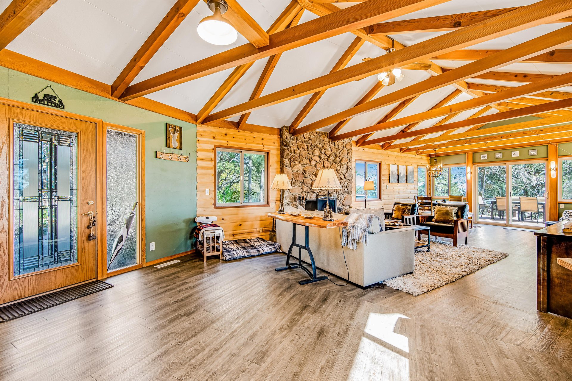 Complete with a wall mounted smart TV, stone fireplace, and plenty of seating.