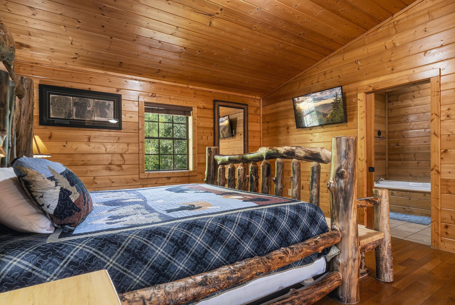 Drift off to sleep surrounded by warm wood walls and rustic log furniture in your cozy cabin bedroom.