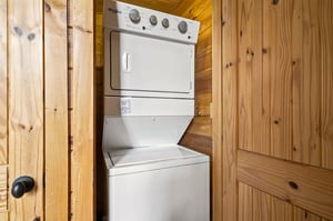 A stacked washer and dryer tucked into a cozy nook, so you can pack light and refresh your wardrobe anytime.