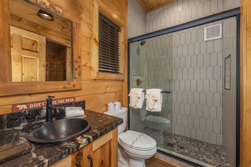 Bathroom with shower off of foyer and bedroom 1