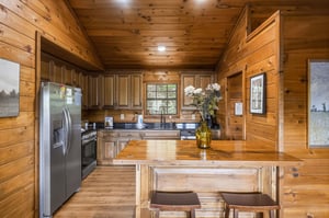 Your fullyequipped kitchen features warm wood finishes, modern appliances, and plenty of counter space for meal prep. Natural light and a welcoming island make this the perfect spot to gather.