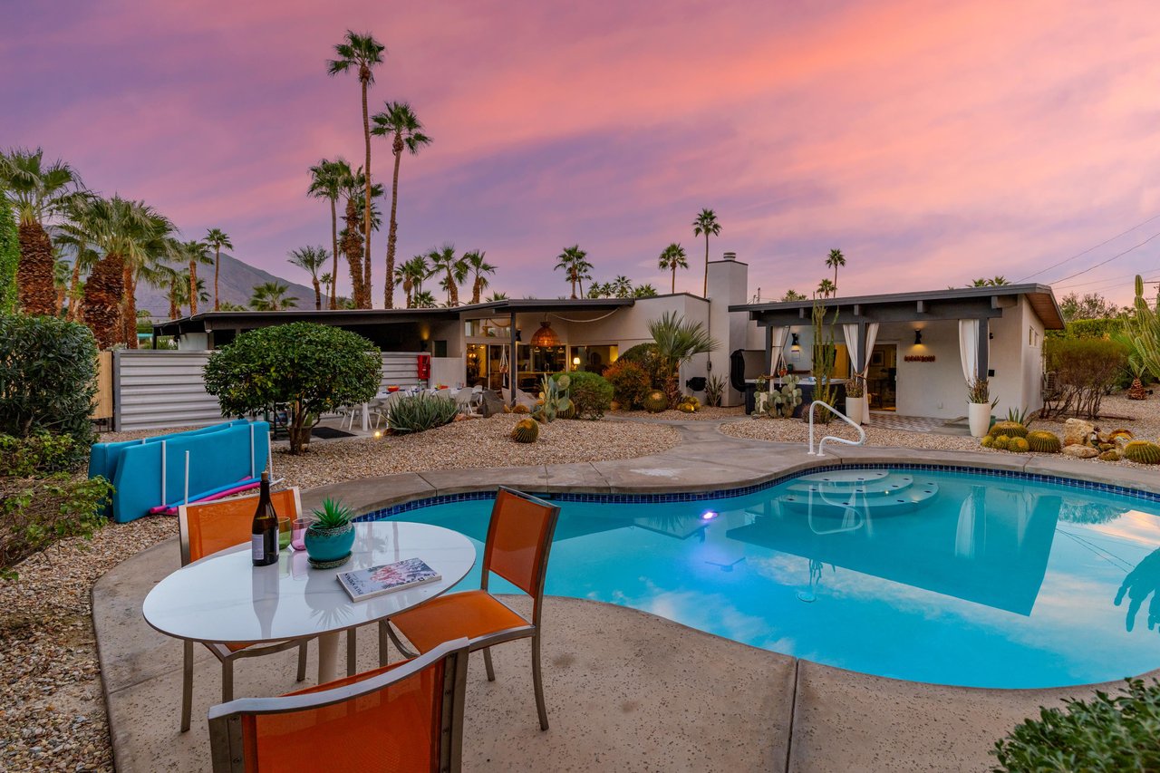 Stunning desert retreat with private pool beneath painted skies and swaying palms in a peaceful residential setting.