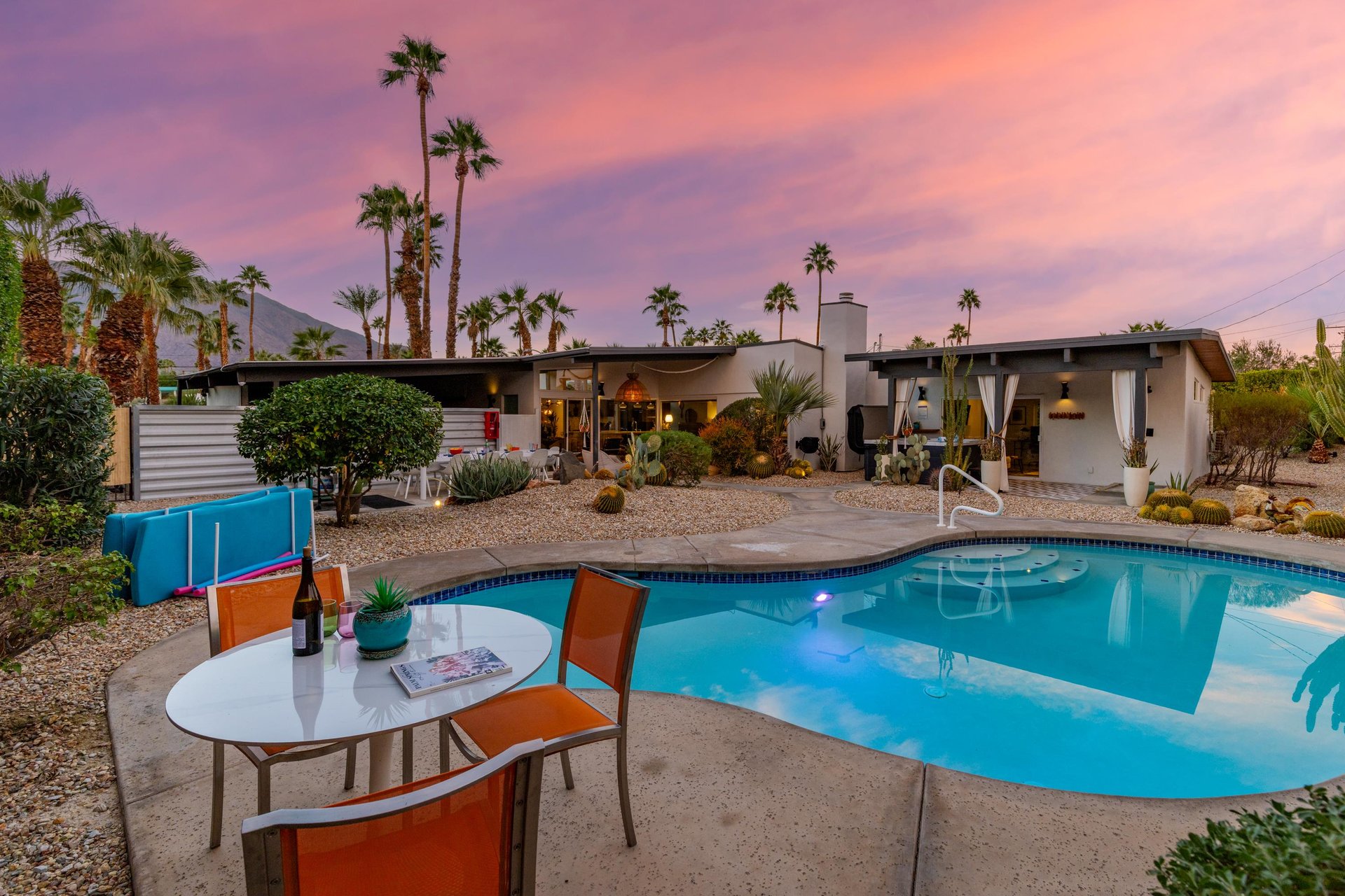 Stunning desert retreat with private pool beneath painted skies and swaying palms in a peaceful residential setting.