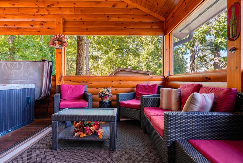 Settle into plush seating surrounded by warm wood and forest views, where your private hot tub awaits just steps away for ultimate relaxation.