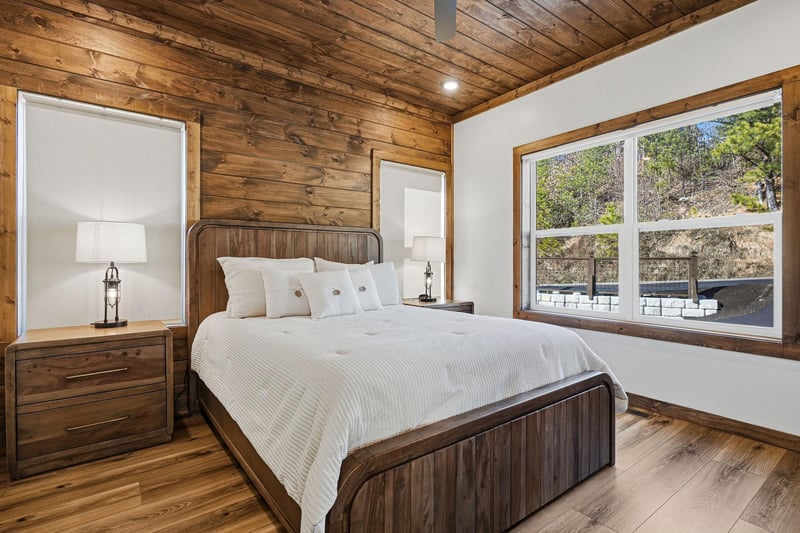 Drift off to sleep in your cozy rustic bedroom, where exposed wooden beams and warm textures create the perfect mountain retreat.