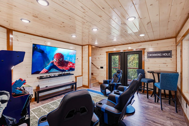 Cozy up in your private game room with theatrestyle seating, a huge screen for movies or gaming, and rustic wood accents that make every moment feel like a retreat.