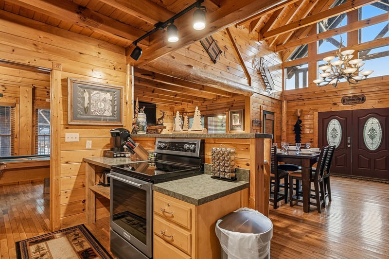 Step into your inviting mountain retreat where soaring woodbeamed ceilings and warm natural light create the perfect setting for gathering, cooking, and making memories in this openconcept kitchen a