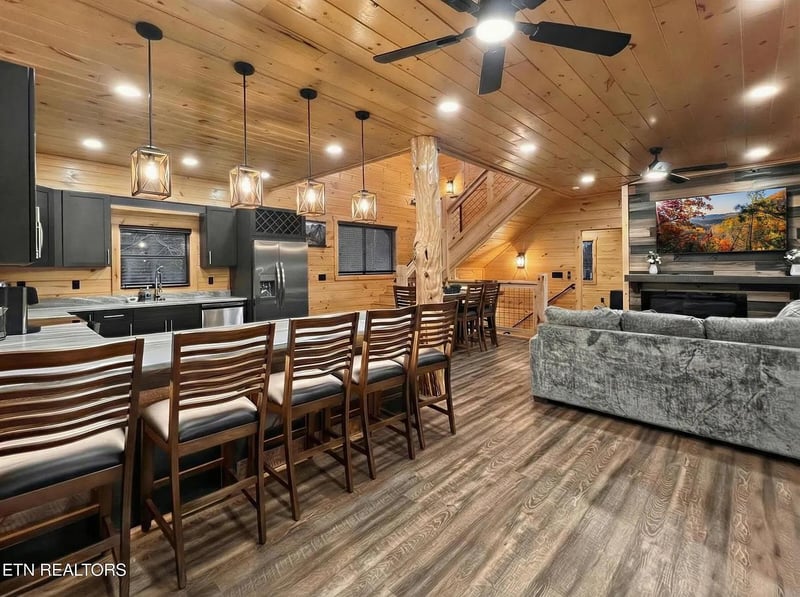 Unwind in this stunning openconcept cabin with soaring wood ceilings, modern kitchen, and cozy fireplace perfect for memorable gatherings.