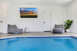 Unwind in your own private indoor pool, complete with cozy loungers and a calming ambiance perfect for relaxation.