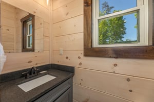 Single vanity sink beside window