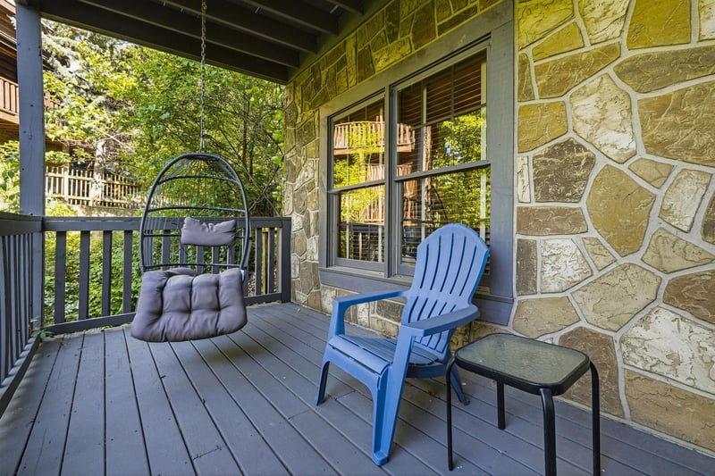 Unwind on your private covered deck with a swing chair and mountain views through the trees.