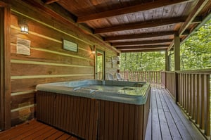 Slip into your private hot tub surrounded by lush forest views, where warm jets and the rustle of leaves create your perfect mountain retreat.