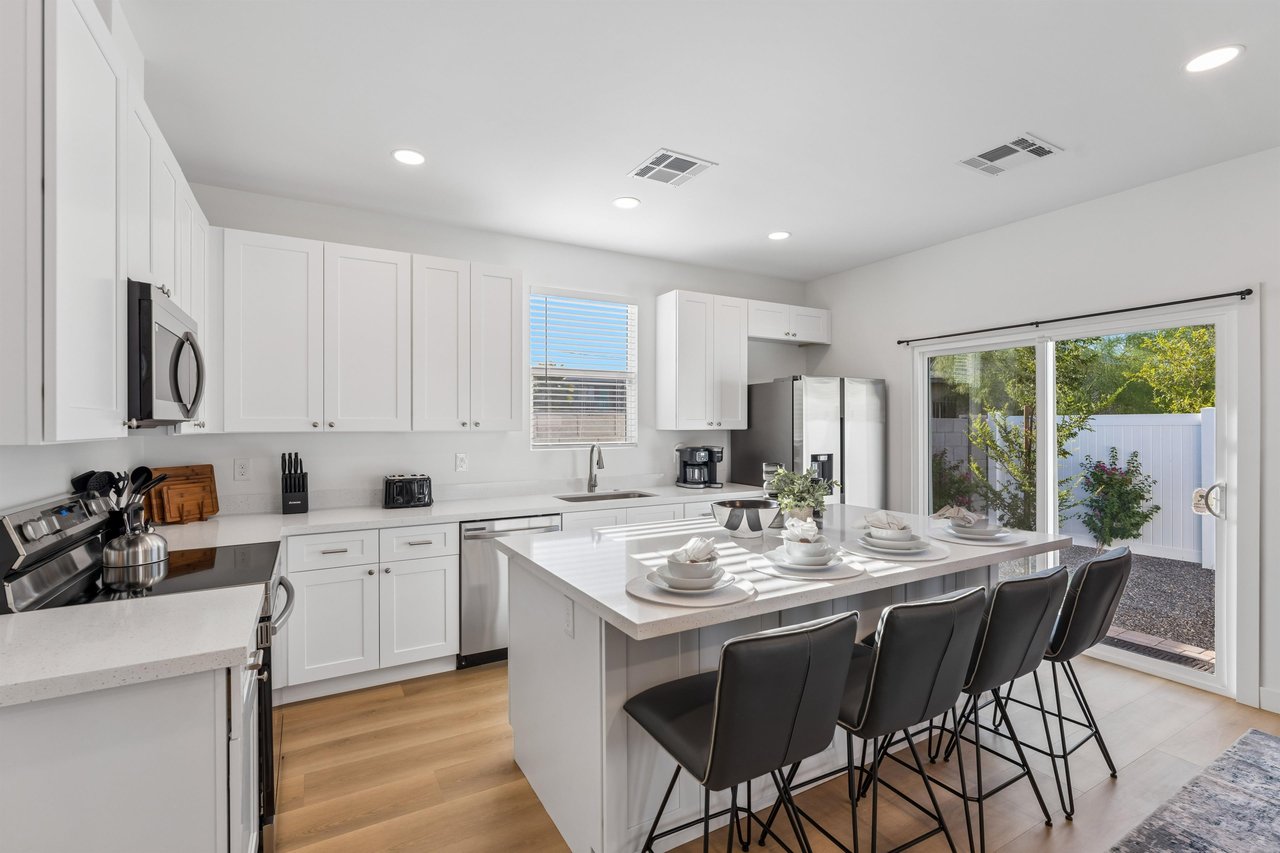 Stainless steel appliances, cooking essentials, counter seating for 4, and yard access.