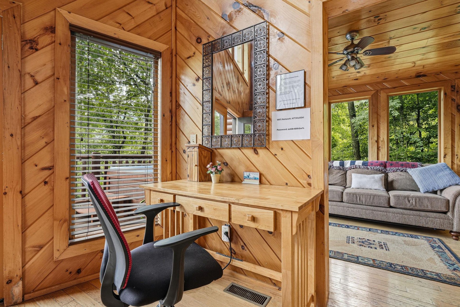 Your own workspace tucked into a cozy corner, framed by warm wood and natural light. Step outside to a private deck or unwind in the open living area nearby.