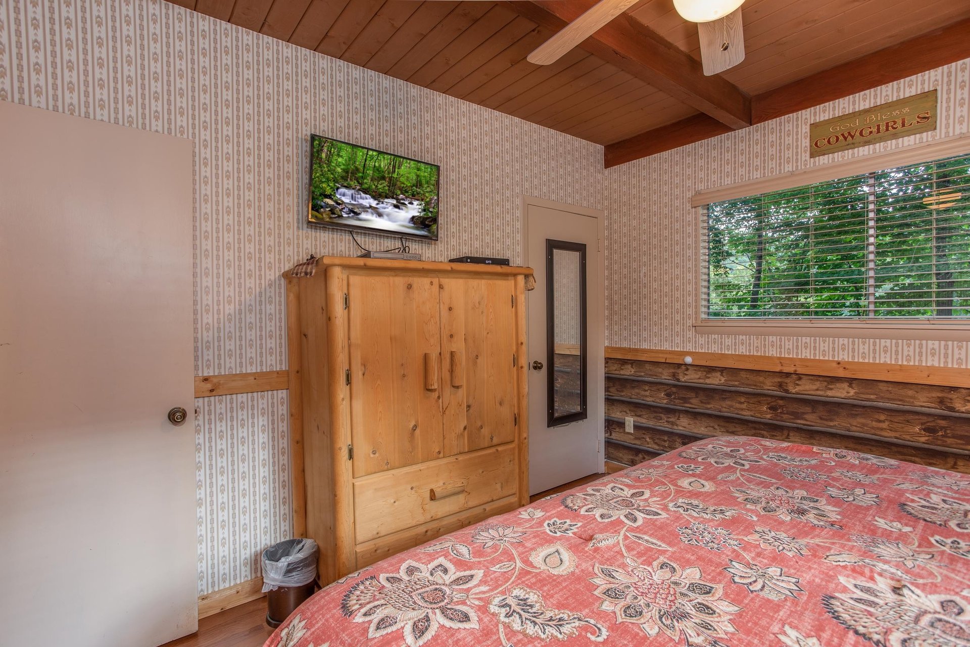 Second bedroom with a television and armoire at Bushwood Lodge, a 3bedroom cabin rental located in Gatlinburg