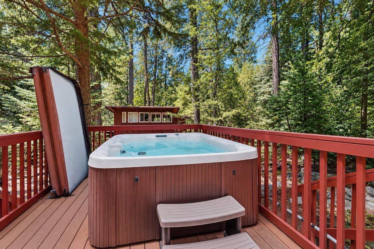 Soak under the pines in your own private hot tub, tucked into the deck with nothing but forest sounds and mountain air around you.