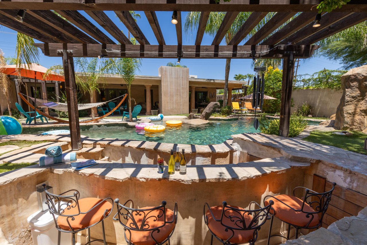 A gorgeous 4 bedroom, 4.5 bathroom home in Palm Springs, CA with 2 casitas, a lazy river, swim up bar, pickleball, basketball, putting green, games, and more