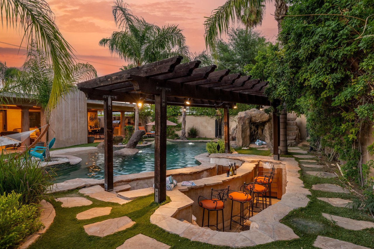 A lazy river, swim up bar, 2 grottos, waterslide, sandy beach, and hammock are a few of the many incredible outdoor amenities available at this beautiful home