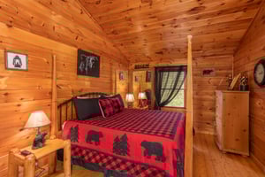 Kingsized fourpost bed in the upper bedroom at Hibernation Station, a 3bedroom cabin rental located in Pigeon Forge