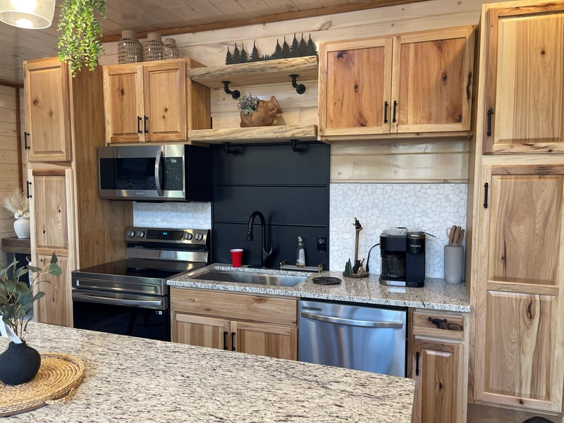Your fully equipped kitchen features warm wood cabinets, granite counters, and modern appliances perfect for preparing memorable meals together.