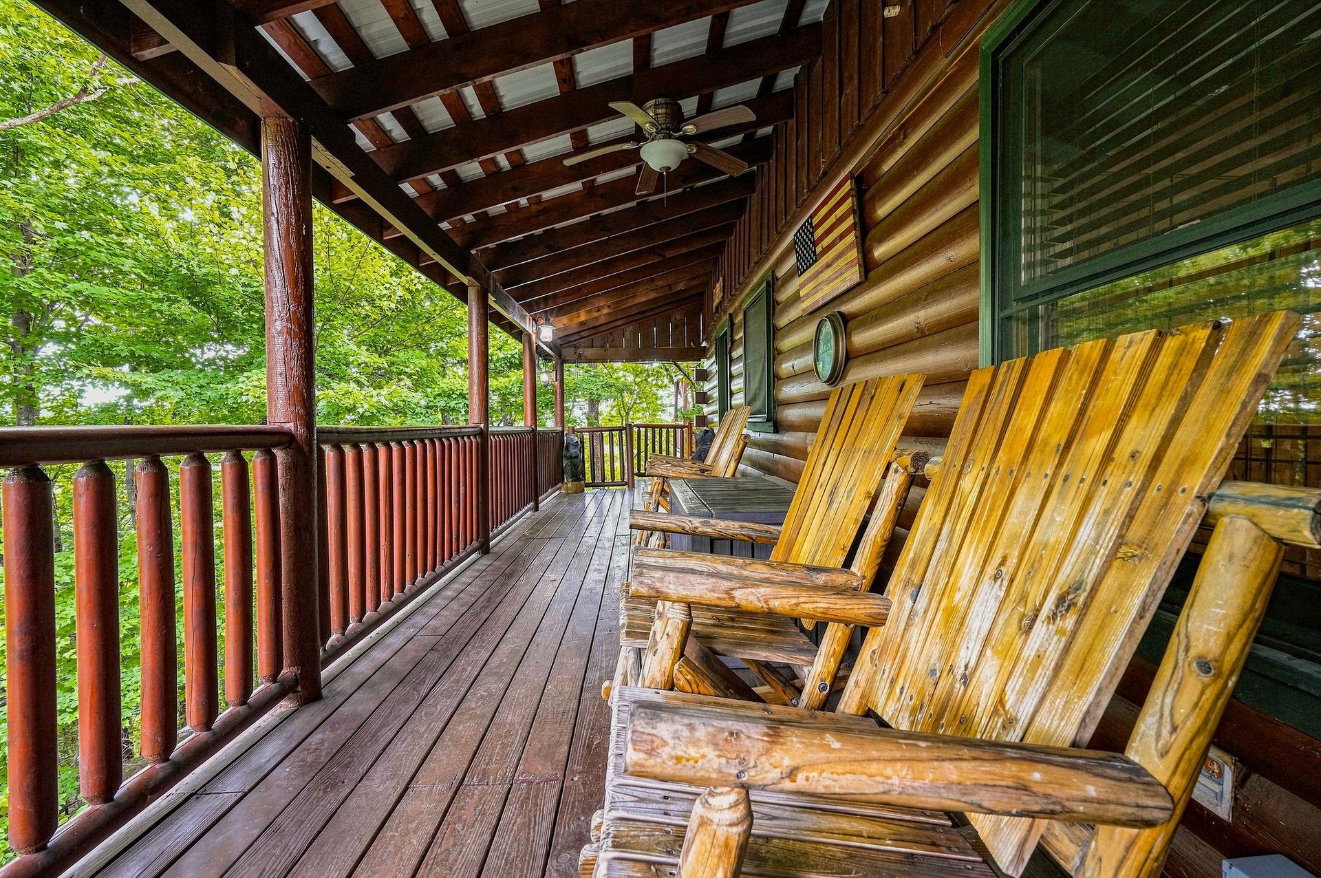 Settle into rustic charm on your private deck, where handcrafted rocking chairs invite you to unwind surrounded by lush forest greenery and mountain tranquility.