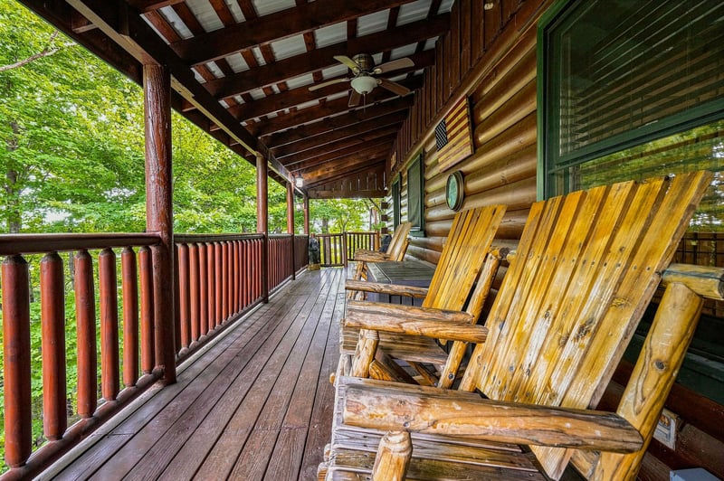 Settle into rustic charm on your private deck, where handcrafted rocking chairs invite you to unwind surrounded by lush forest greenery and mountain tranquility.