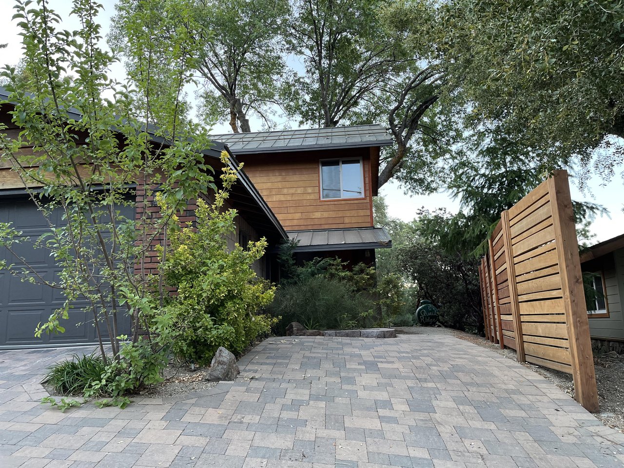 View to additional parking next to the garage and private entrance to the downstairs guest bedroom.