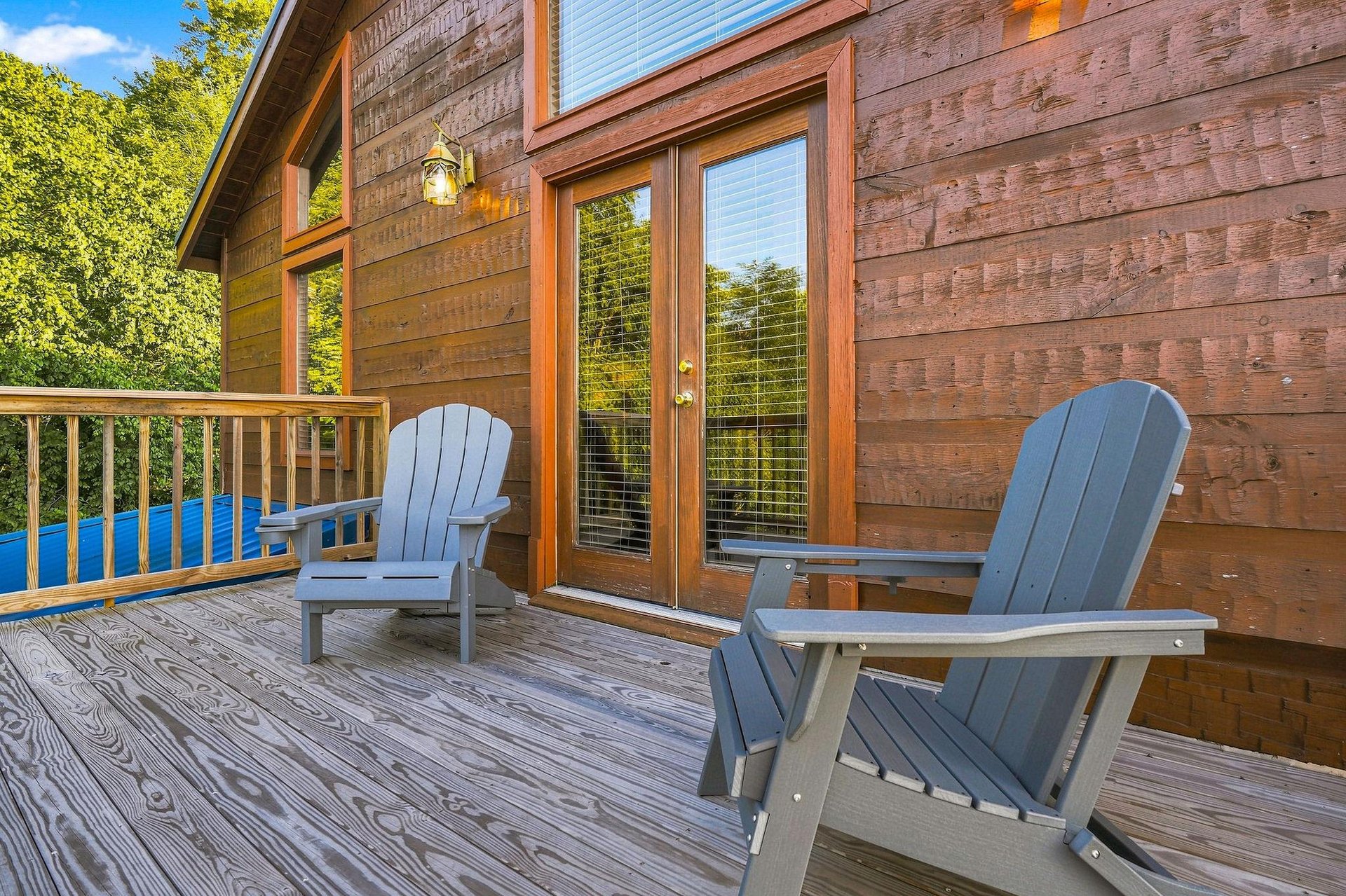Step out onto your private deck and settle into an Adirondack chair, where warm wood tones and peaceful tree views create the perfect spot to unwind with morning coffee or evening conversation.