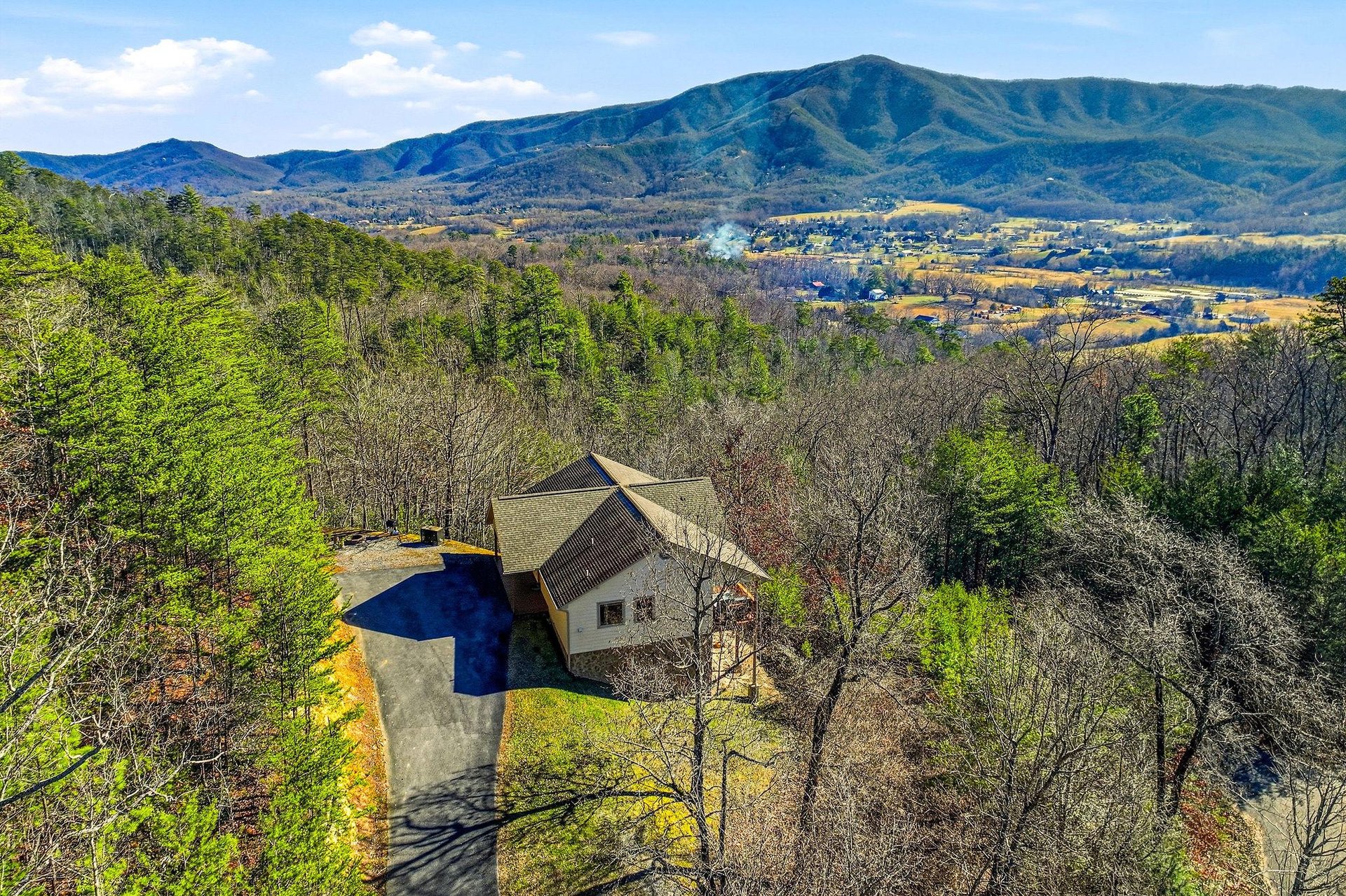 Elevated mountain retreat nestled among rolling hills with sweeping valley views and private swimming pool surrounded by nature.