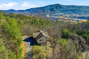 Elevated mountain retreat nestled among rolling hills with sweeping valley views and private swimming pool surrounded by nature.