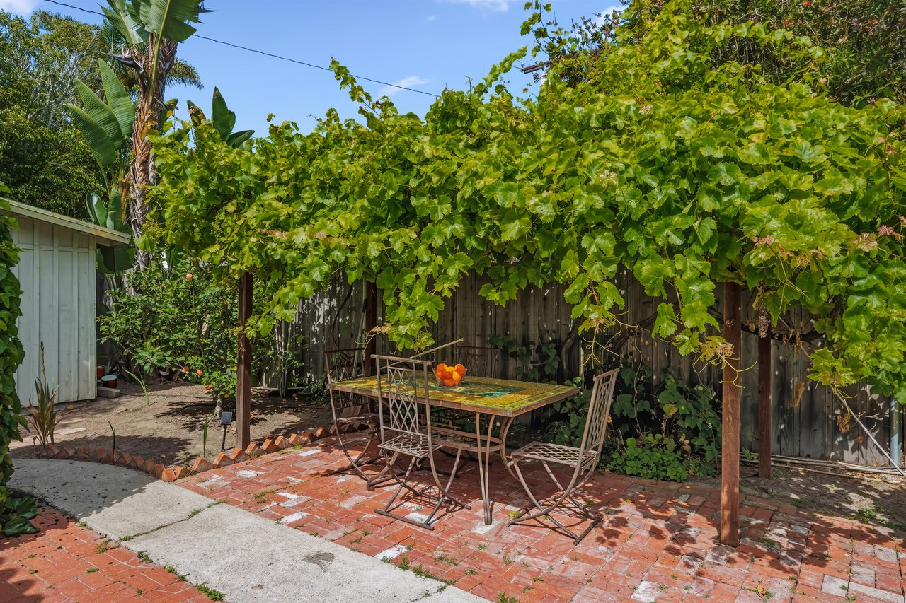 Stunning patio with mosaic tiles, outdoor seating, and an outdoor shower.