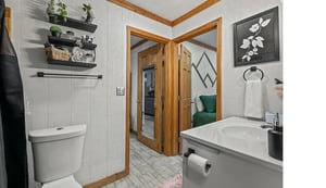 Relax in your stylish bathroom with modern fixtures and thoughtful touches like plants and art creating a spalike retreat.