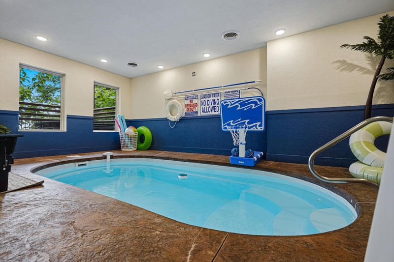 Your private indoor pool awaits, complete with a basketball hoop and tropical vibes for endless family fun and relaxation, no matter the weather outside.