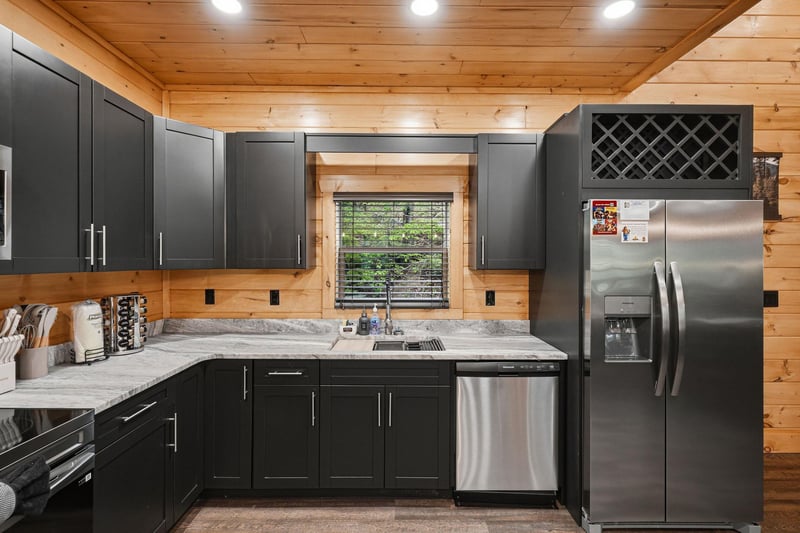 Your fully equipped kitchen features granite counters and stainless appliances, perfect for preparing memorable meals in your mountain retreat.