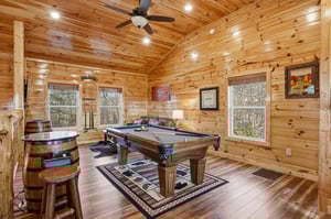 Challenge friends to pool games in your cozy woodpaneled game room, complete with rustic bar seating and mountain views.