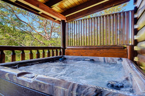 Slip into your private hot tub on this serene covered deck, surrounded by lush forest views and mountain fresh air.